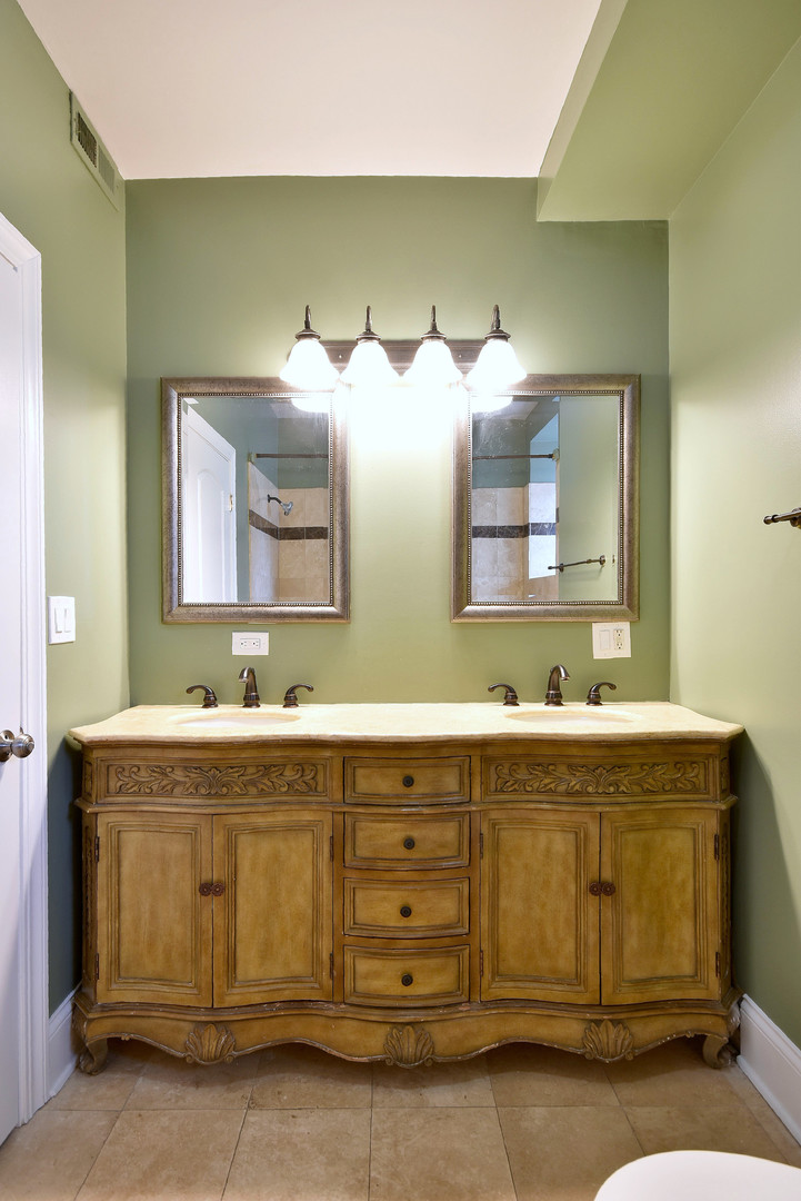 4819 South Prairie Avenue, Unit 1 Chicago, IL 60615 - Photo 10 of 16 a bathroom with a sink and two mirror