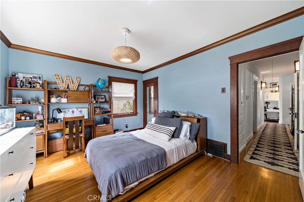 310 Loma Avenue Long Beach, CA 90814 - Photo 21 of 71 a bedroom with a bed and wooden floor