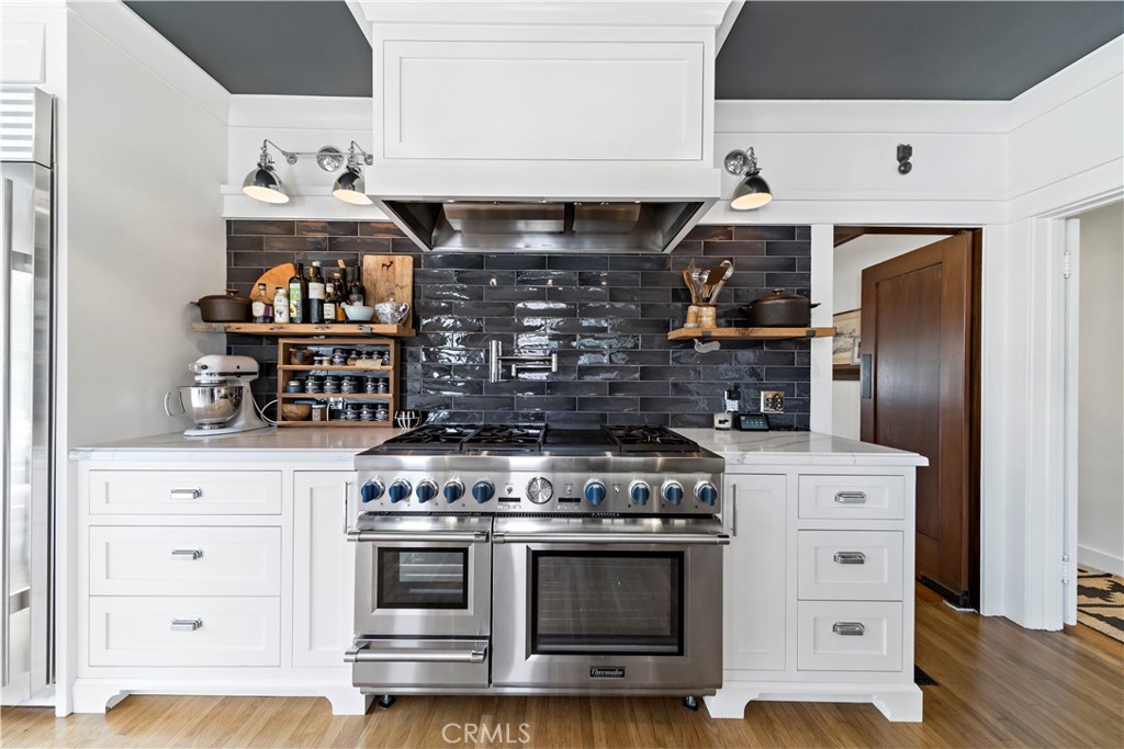 310 Loma Avenue Long Beach, CA 90814 - Photo 6 of 71 a kitchen with stainless steel appliances granite countertop a stove and a refrigerator