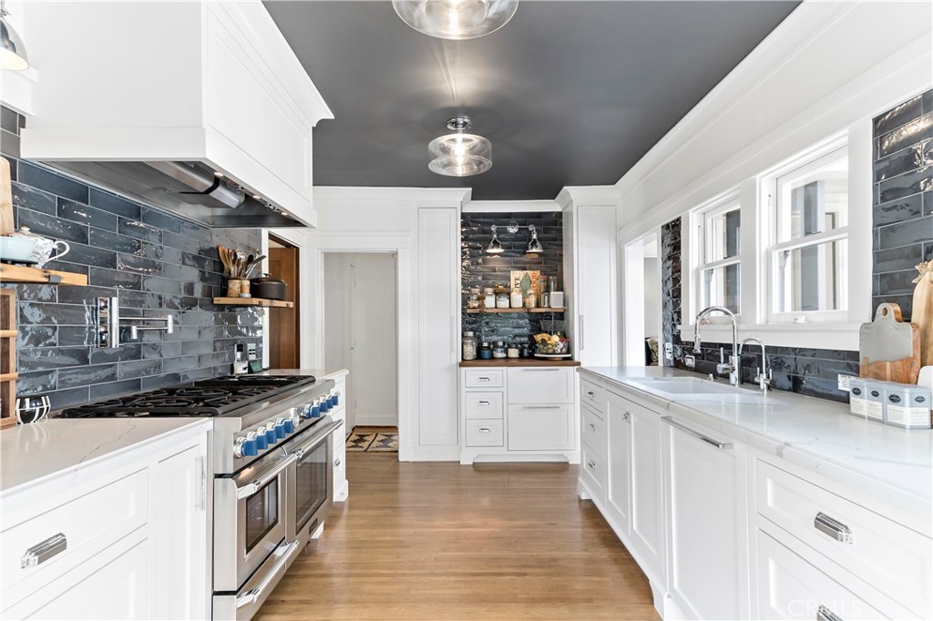 310 Loma Avenue Long Beach, CA 90814 - Photo 8 of 71 a kitchen that has a lot of cabinets in it