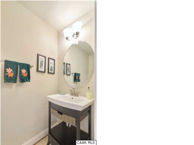 5346 Raven Stone Road Crozet, VA 22932 - Photo 18 of 25 a bathroom with a sink a mirror and a toilet