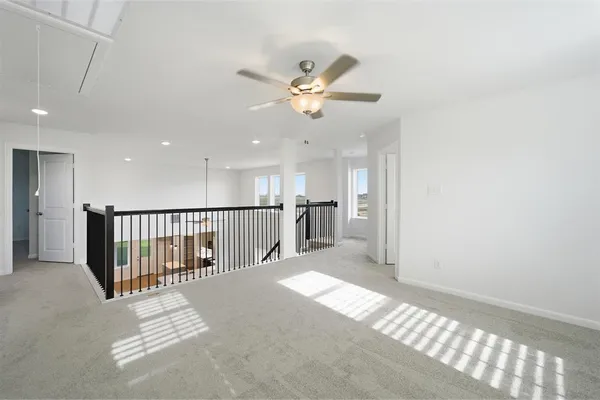 a view of a livingroom with a ceiling fan and window