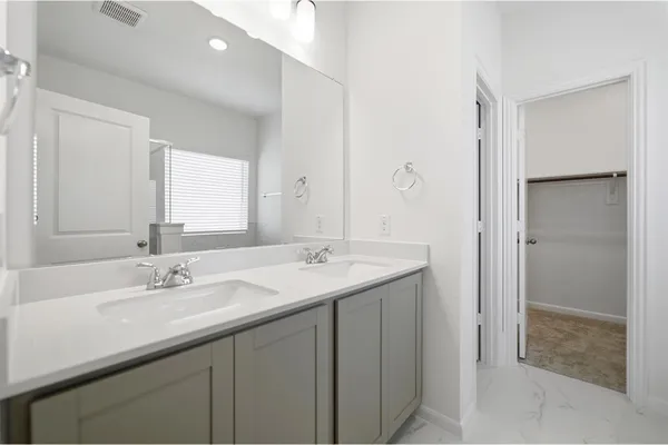 a bathroom with a sink double vanity and a mirror