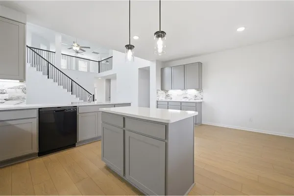 a kitchen with a sink and cabinets