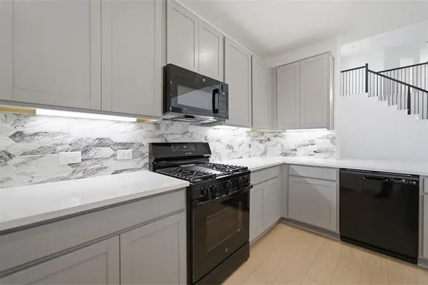 a kitchen with a sink stove and microwave