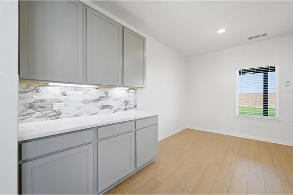 a room with a sink and cabinets