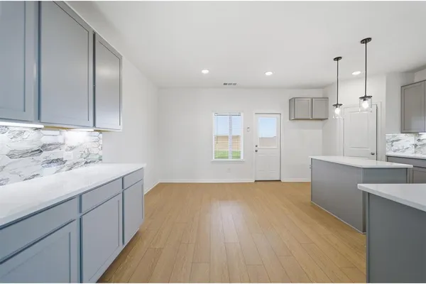 a view of a kitchen with a sink and dishwasher wooden cabinets