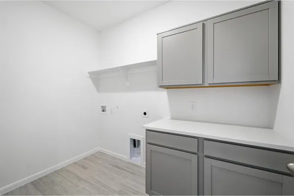 a view of storage and utility room with wooden floor