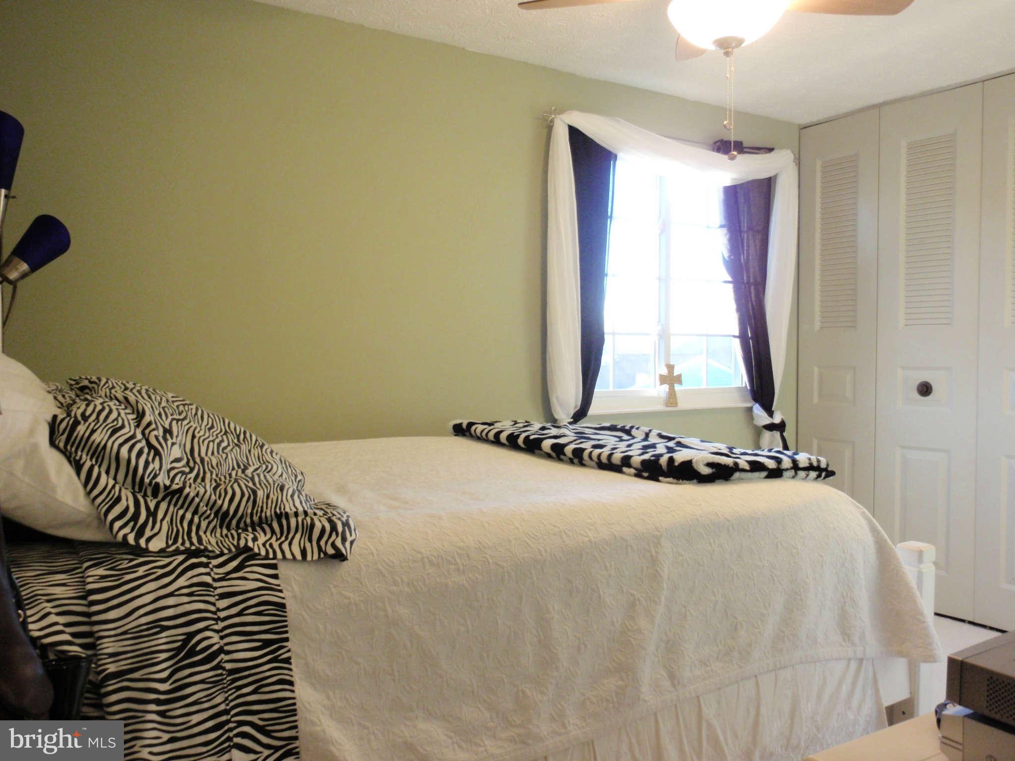 12139 Purple Sage Court Reston, VA 20194 - Photo 12 of 21 a bedroom with a bed and a window