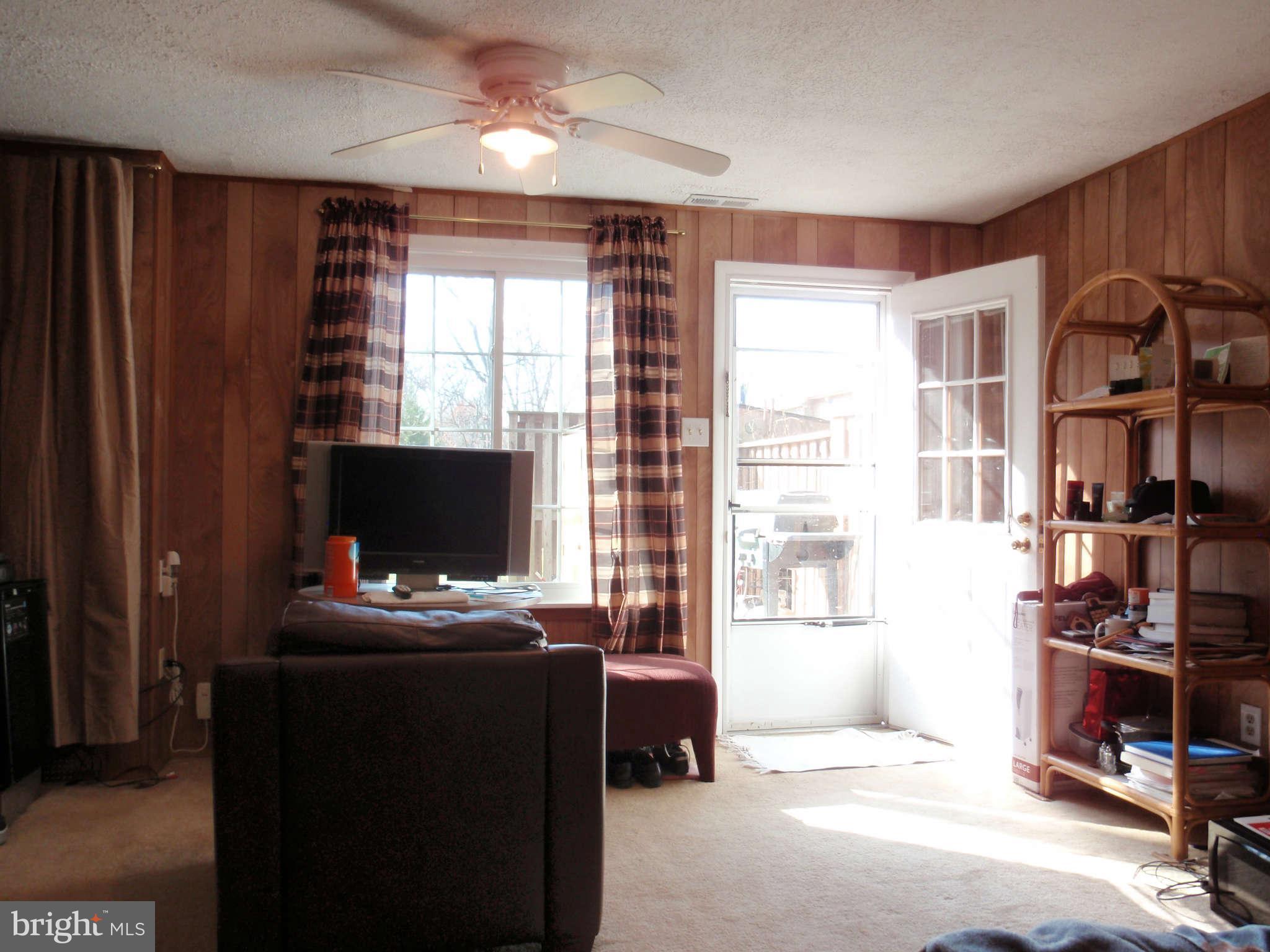 12139 Purple Sage Court Reston, VA 20194 - Photo 13 of 21 a bedroom with furniture a flat screen tv and a window