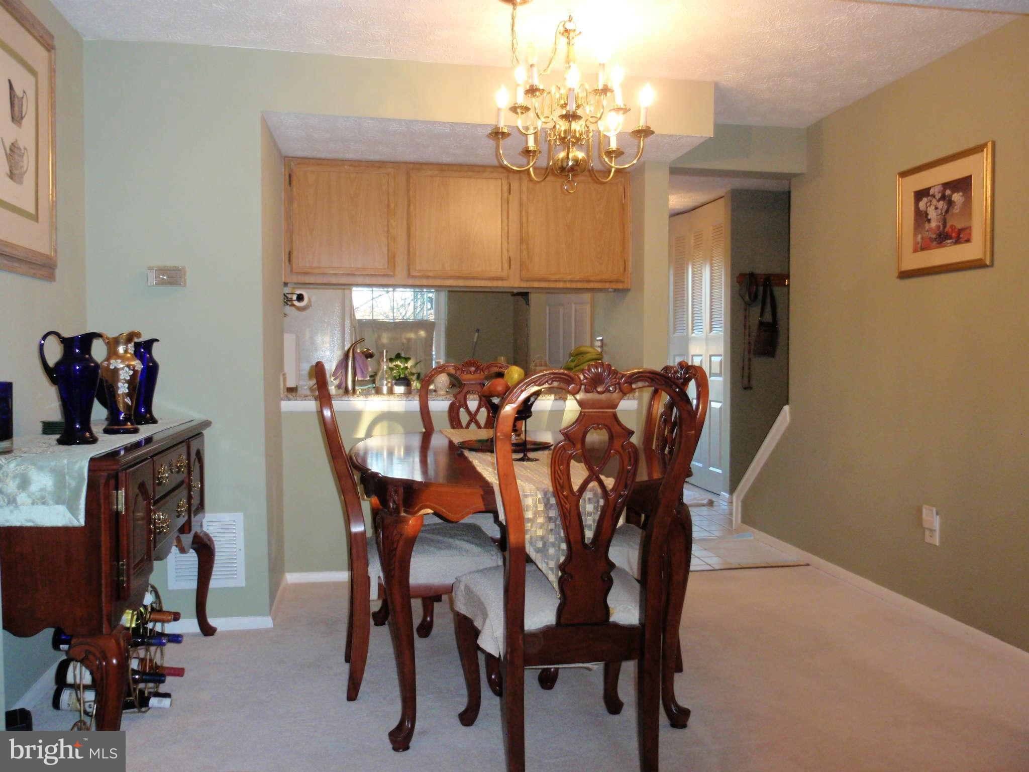 12139 Purple Sage Court Reston, VA 20194 - Photo 4 of 21 a view of a dining room with furniture and chandelier