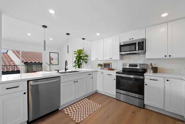 a kitchen with a sink stove and microwave