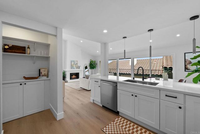 a kitchen with white cabinets sink and white appliances