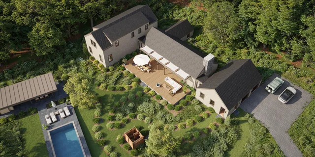 an aerial view of a house with a yard and garden