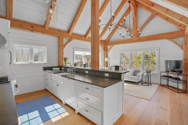 a large white kitchen with a large window