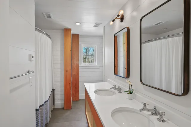 a bathroom with a double vanity sink mirror and double