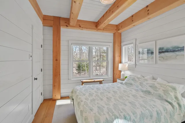 a spacious bedroom with a large bed and a large window