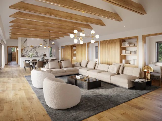 a living room with couches a chandelier and kitchen view