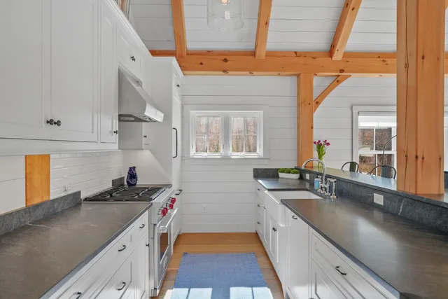 a kitchen with stainless steel appliances a sink stove and cabinets