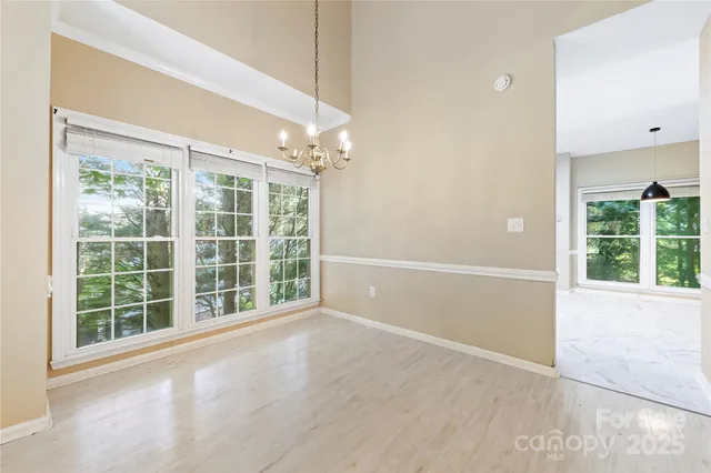 an empty room with windows and outdoor view