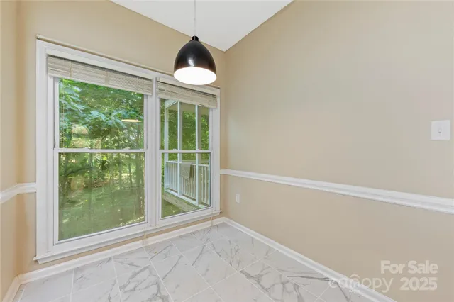 a view of a room with wooden floor and windows