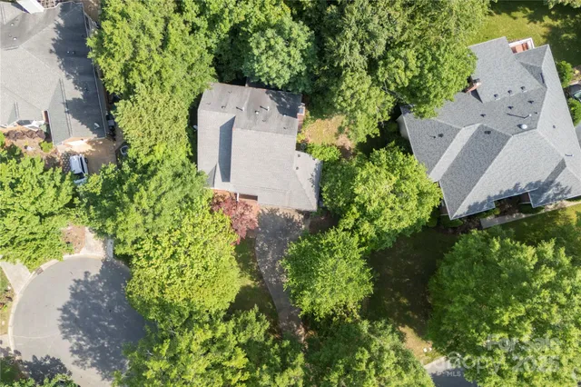 an aerial view of a house with a yard and garden