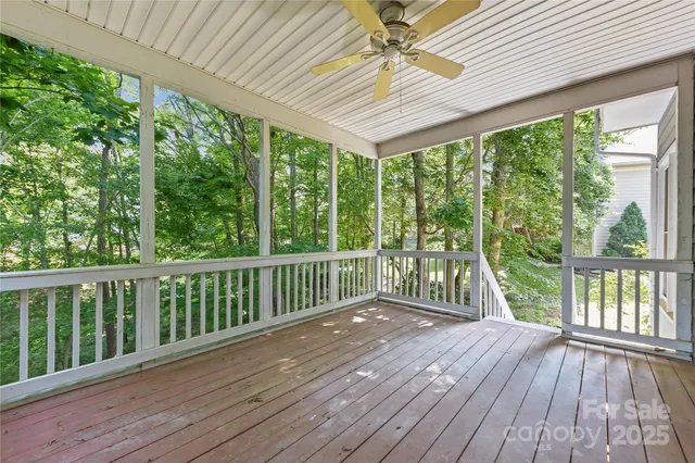a view of a wooden deck with a yard