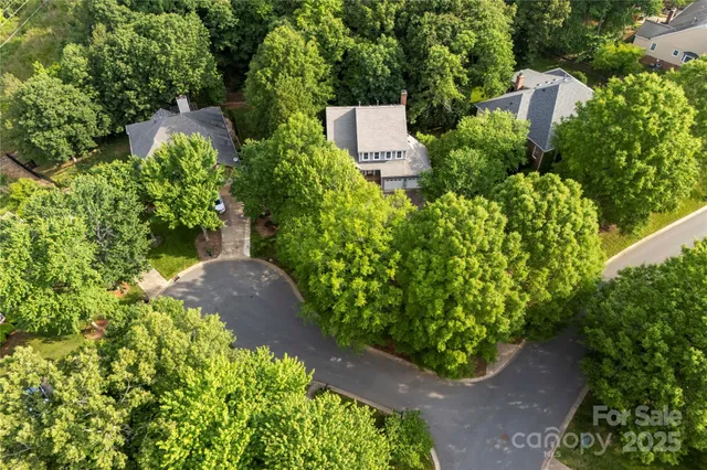 an aerial view of a house with a yard and garden