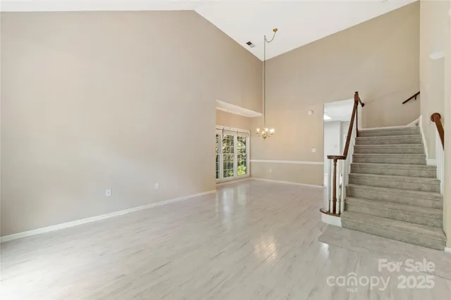 a view of an empty room with stairs