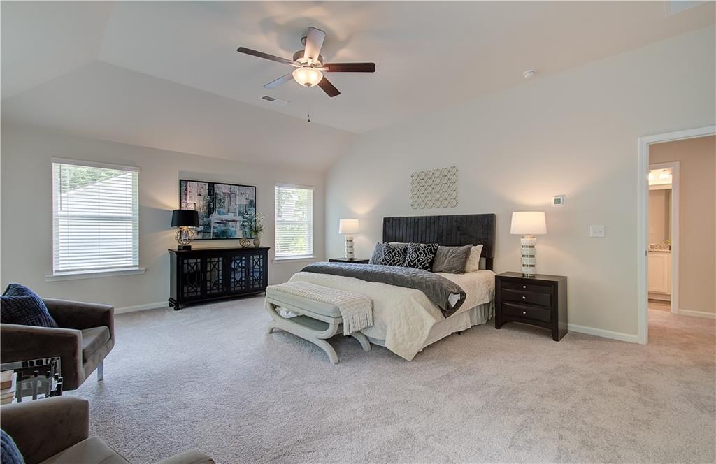 2713 Riverpine Trail Atlanta, GA 30331 - Photo 13 of 15 a spacious bedroom with a bed a couch and a chandelier