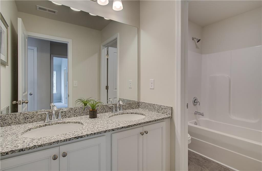 2713 Riverpine Trail Atlanta, GA 30331 - Photo 7 of 15 a bathroom with a granite countertop sink and a mirror