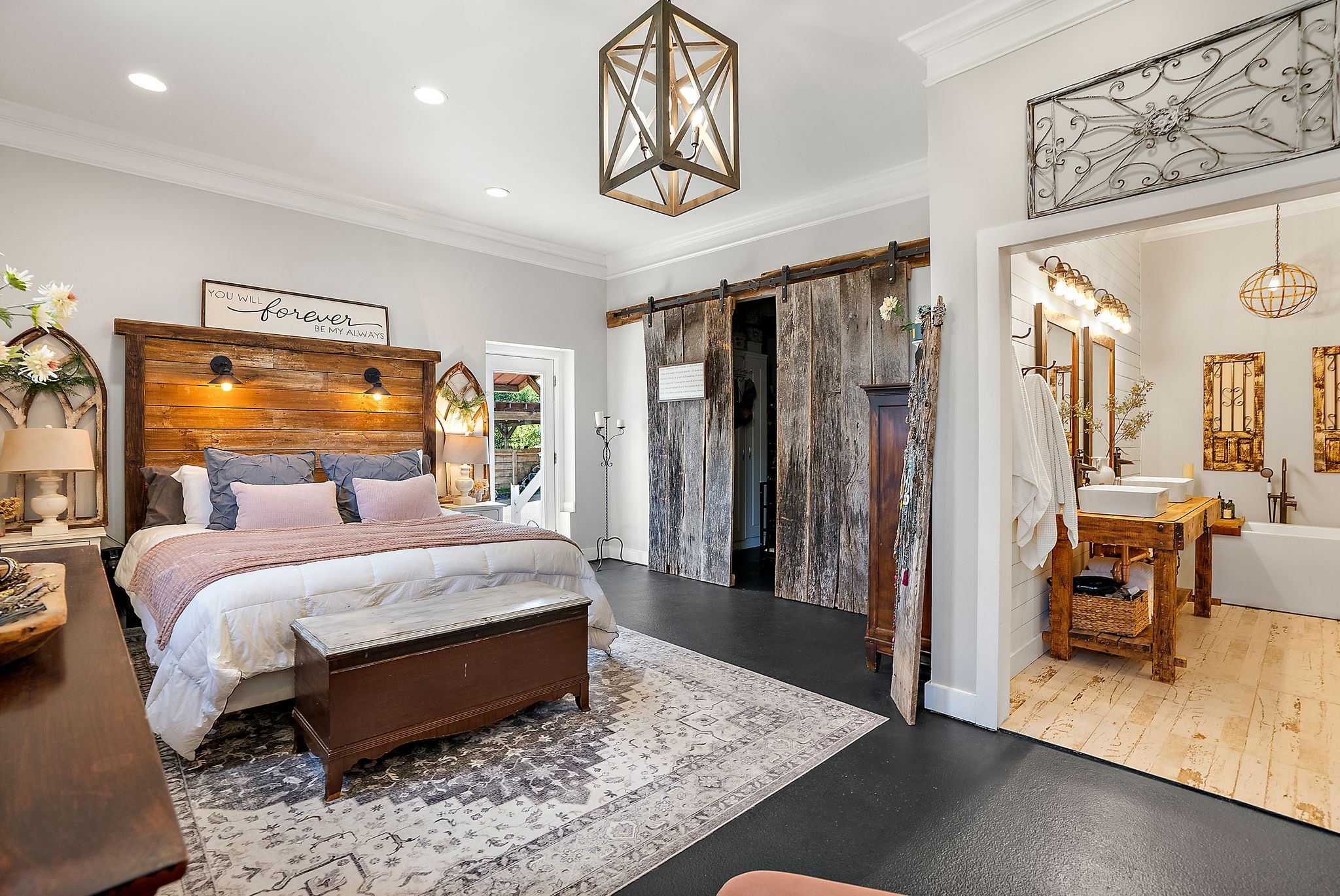 1633 Saundersville Road Hendersonville, TN 37075 - Photo 24 of 71 a bedroom with a large bed and a chandelier