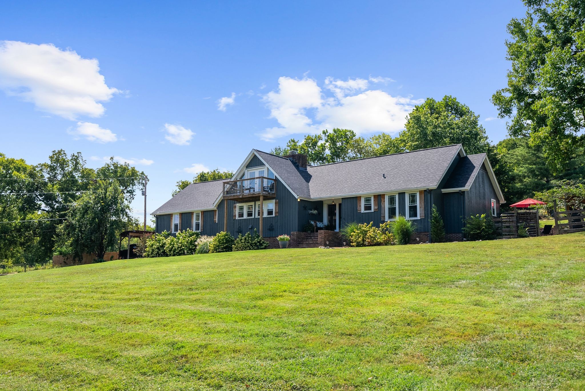 1633 Saundersville Road Hendersonville, TN 37075 - Photo 4 of 71 a view of a house next to a big yard with large trees