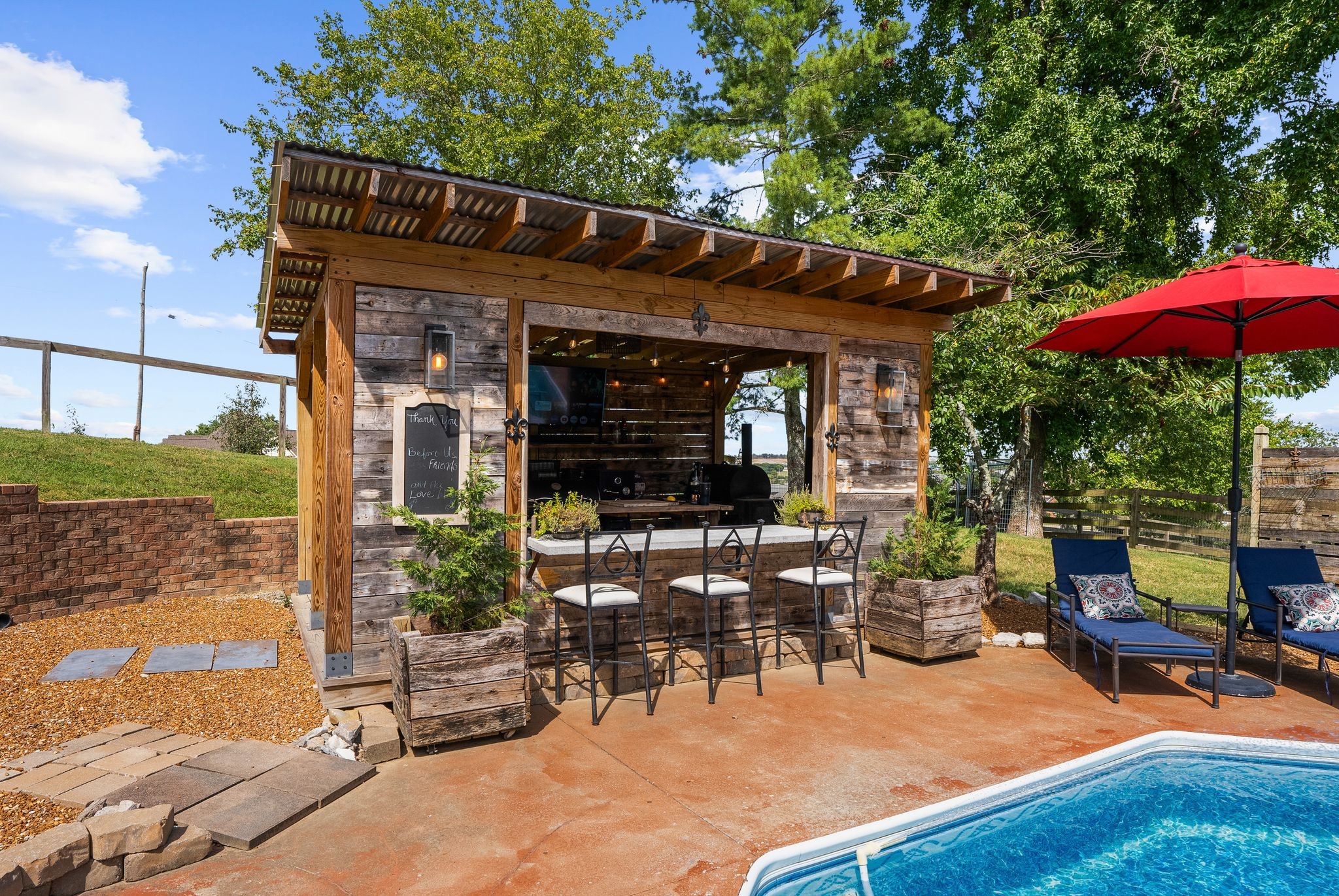 1633 Saundersville Road Hendersonville, TN 37075 - Photo 53 of 71 a patio with a table and chairs under an umbrella