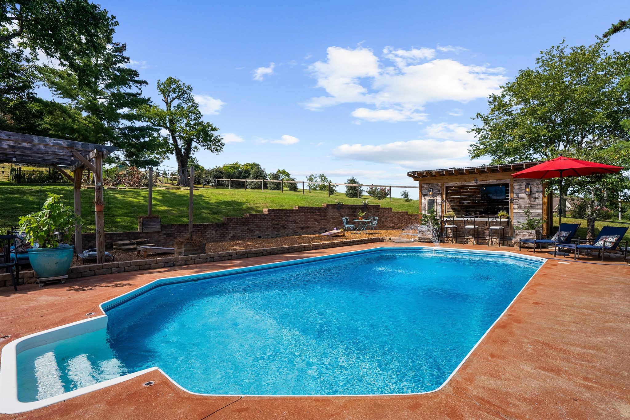 1633 Saundersville Road Hendersonville, TN 37075 - Photo 59 of 71 a view of swimming pool with seating area and trees in the background
