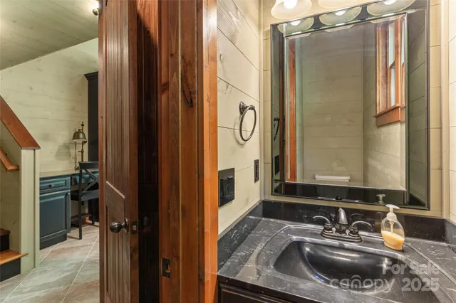 a bathroom with a sink a mirror and a shower