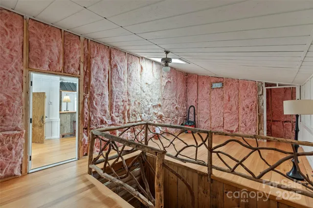 a view of a room with a window and a ceiling fan