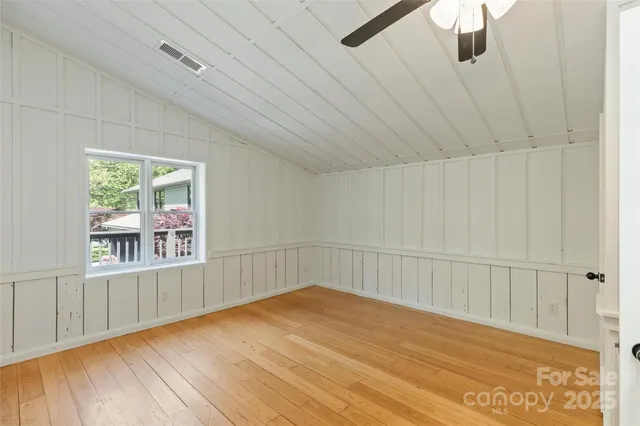 a kitchen with a wooden floor and a sink
