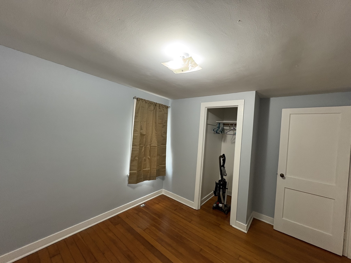 9758 East Flagg Road Rochelle, IL 61068 - Photo 13 of 22 an empty room with wooden floor and closet