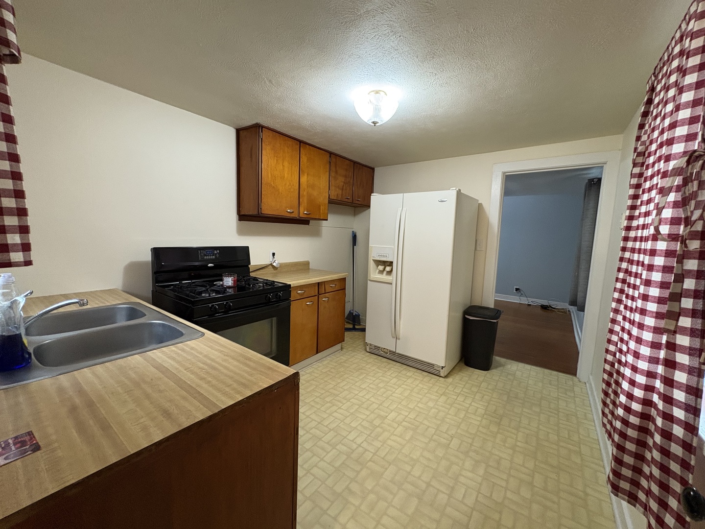 9758 East Flagg Road Rochelle, IL 61068 - Photo 5 of 22 a kitchen with stainless steel appliances a refrigerator and a sink