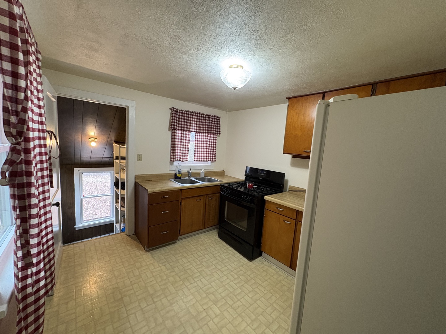 9758 East Flagg Road Rochelle, IL 61068 - Photo 6 of 22 a kitchen with a refrigerator and a sink