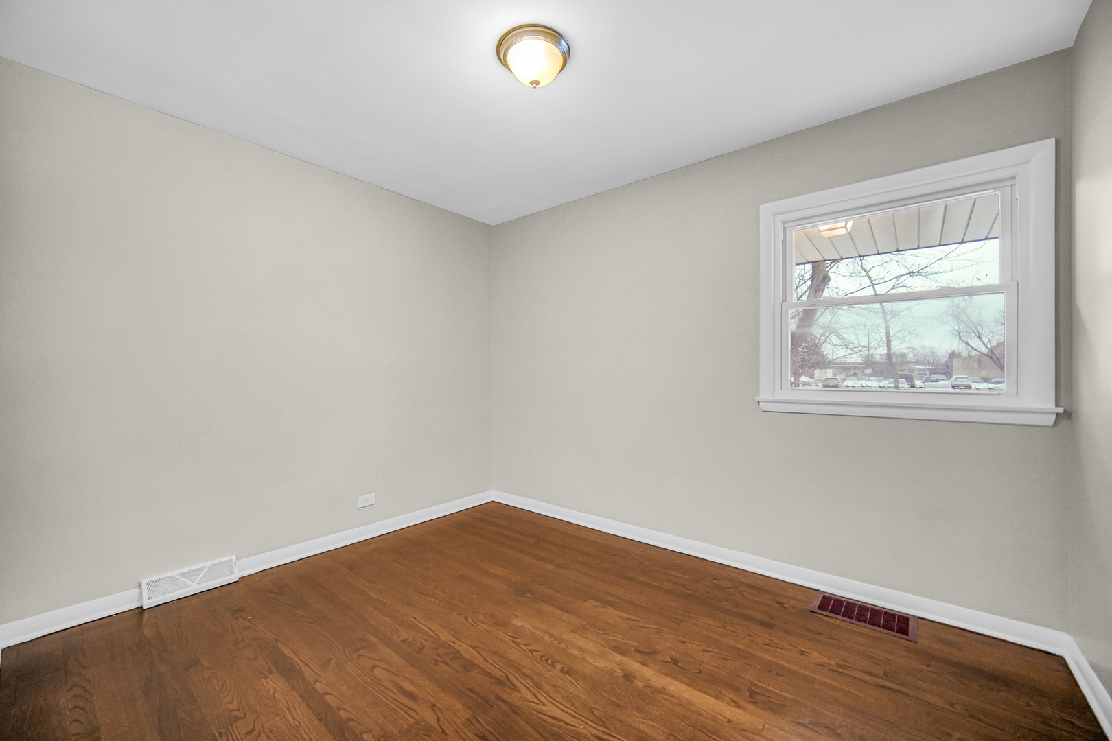 18144 Aberdeen Street Homewood, IL 60430 - Photo 12 of 25 a view of an empty room with wooden floor and a window