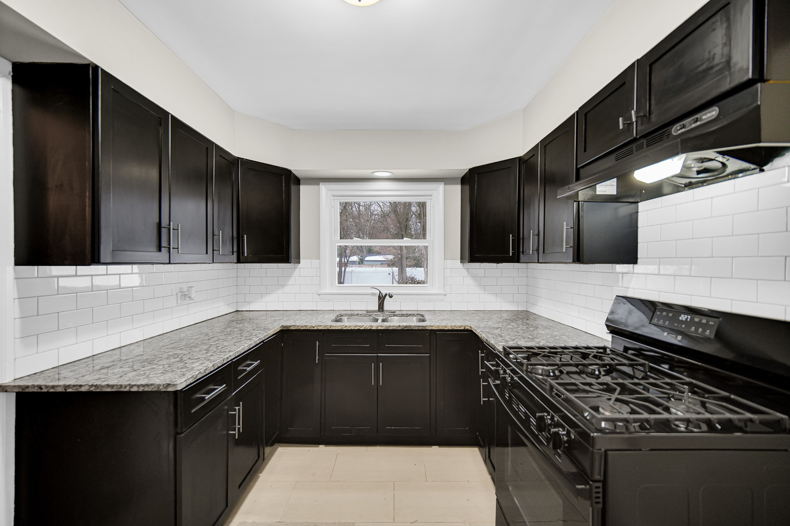 18144 Aberdeen Street Homewood, IL 60430 - Photo 14 of 25 a kitchen with a sink stove and cabinets
