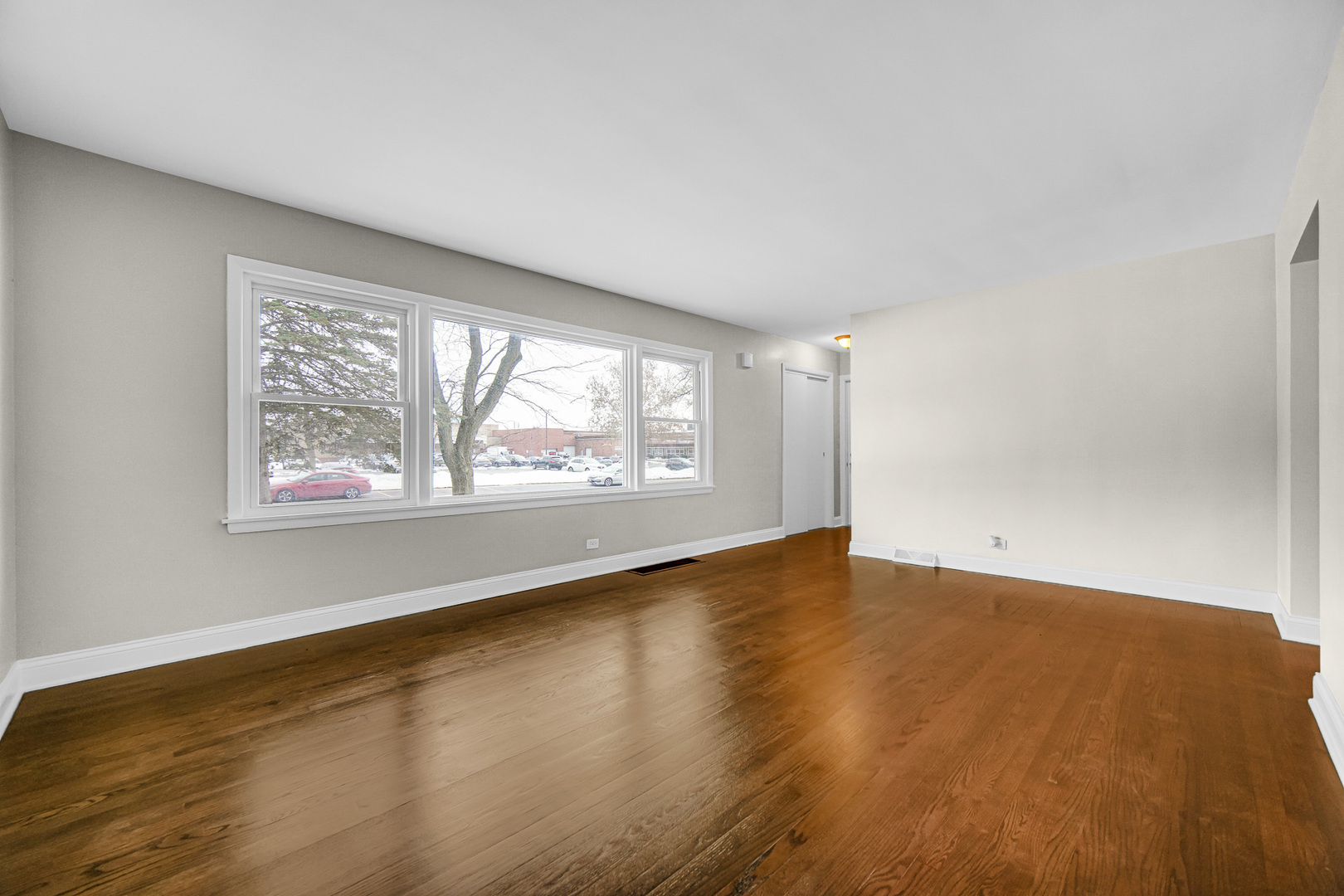 18144 Aberdeen Street Homewood, IL 60430 - Photo 3 of 25 an empty room with wooden floor and windows