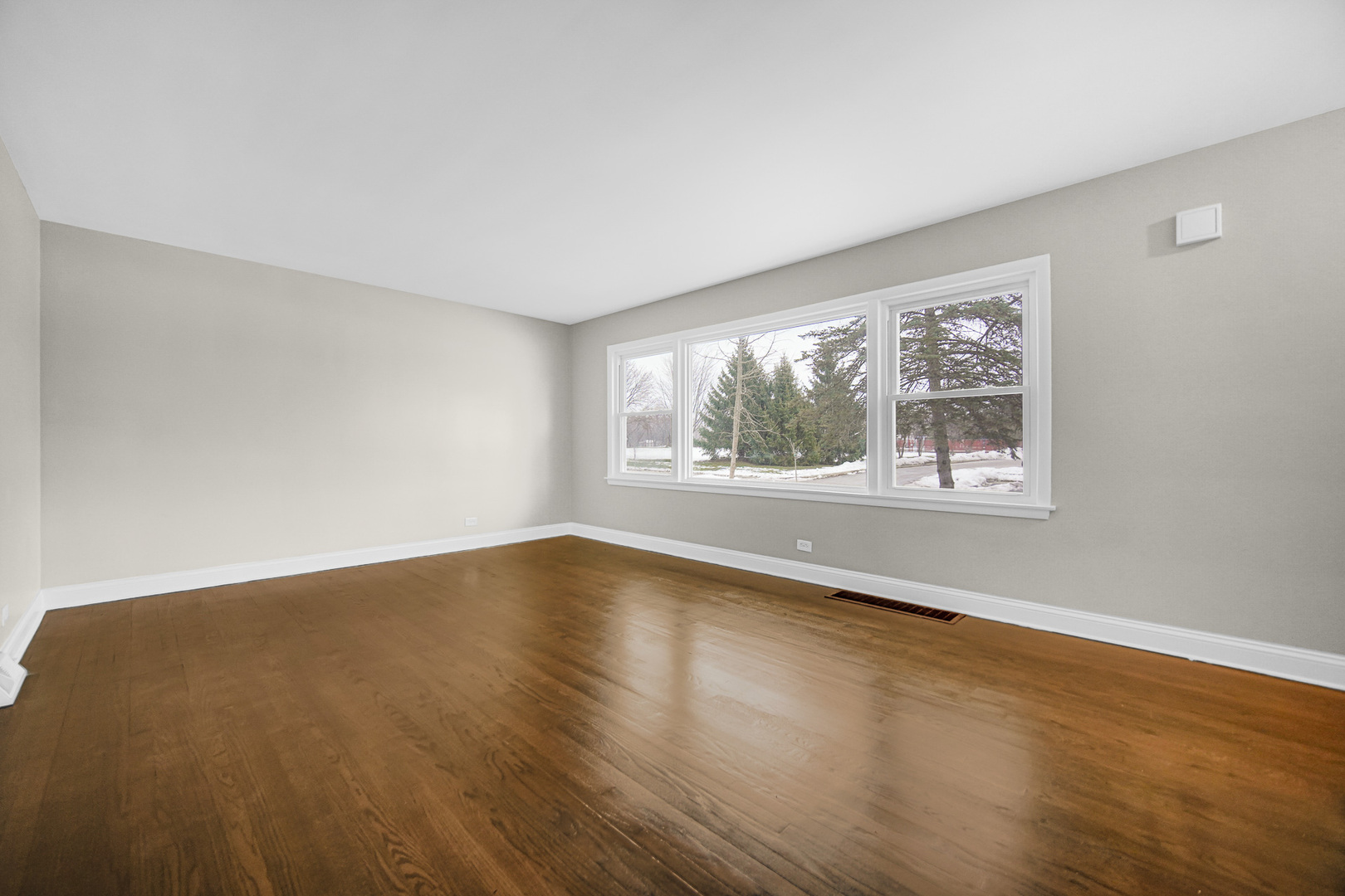 18144 Aberdeen Street Homewood, IL 60430 - Photo 4 of 25 a view of an empty room with wooden floor and a window