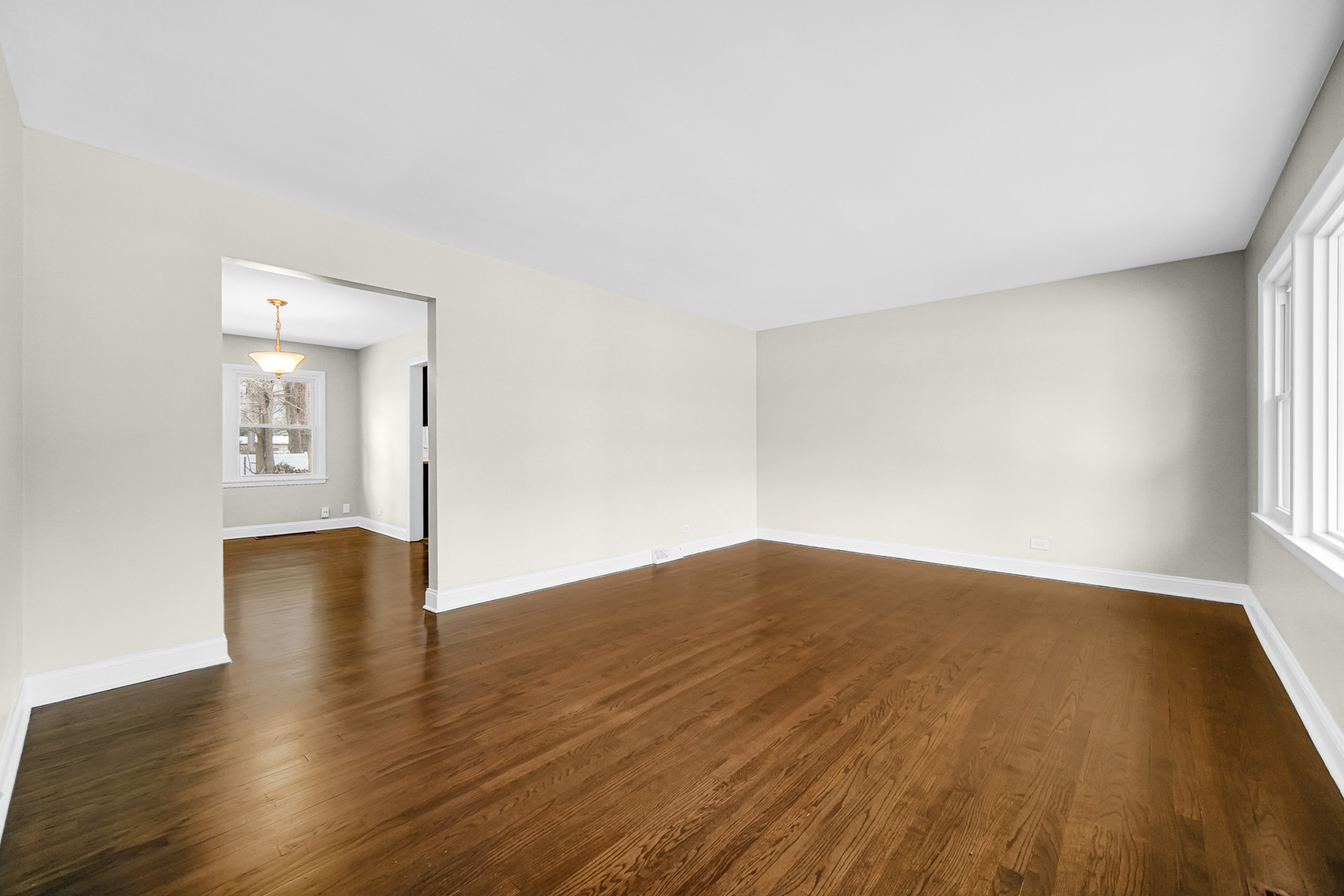 18144 Aberdeen Street Homewood, IL 60430 - Photo 5 of 25 an empty room with wooden floor and windows