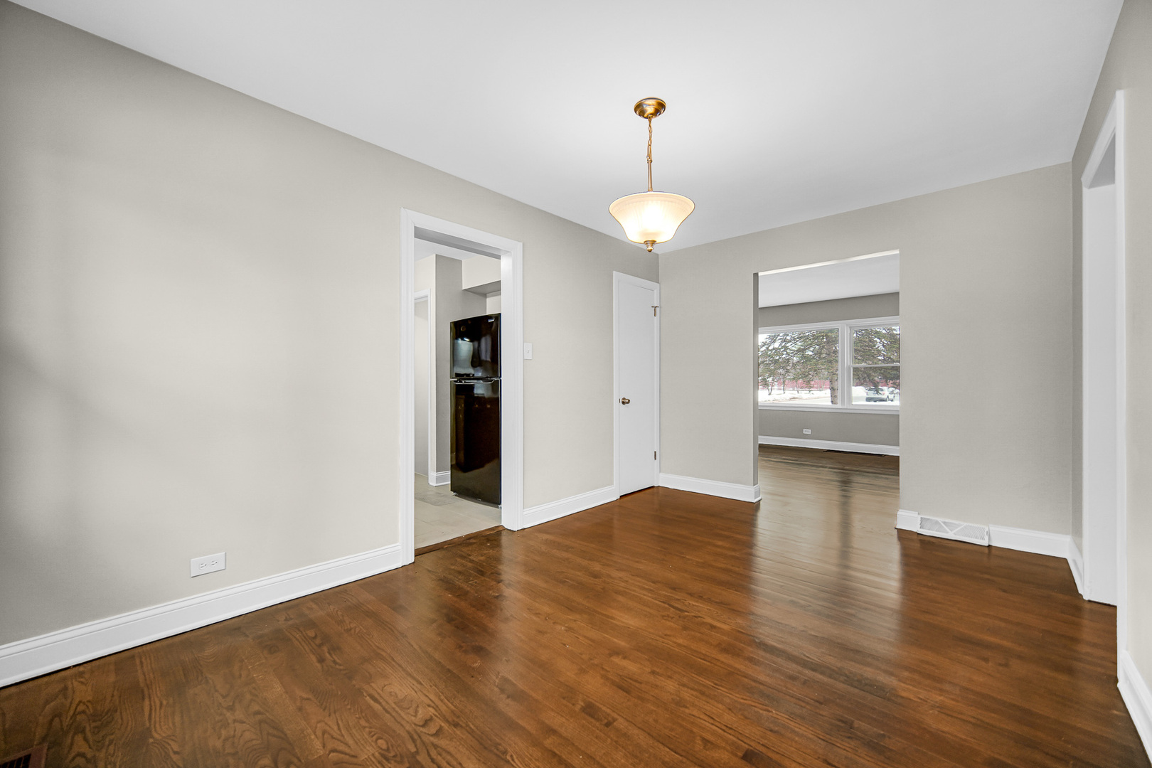 18144 Aberdeen Street Homewood, IL 60430 - Photo 7 of 25 a view of an empty room with a window and wooden floor