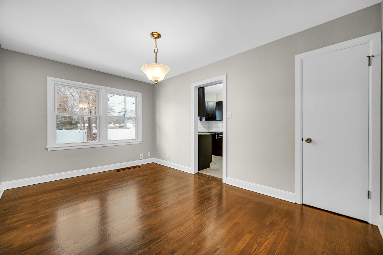 18144 Aberdeen Street Homewood, IL 60430 - Photo 8 of 25 a view of an empty room with window and wooden floor