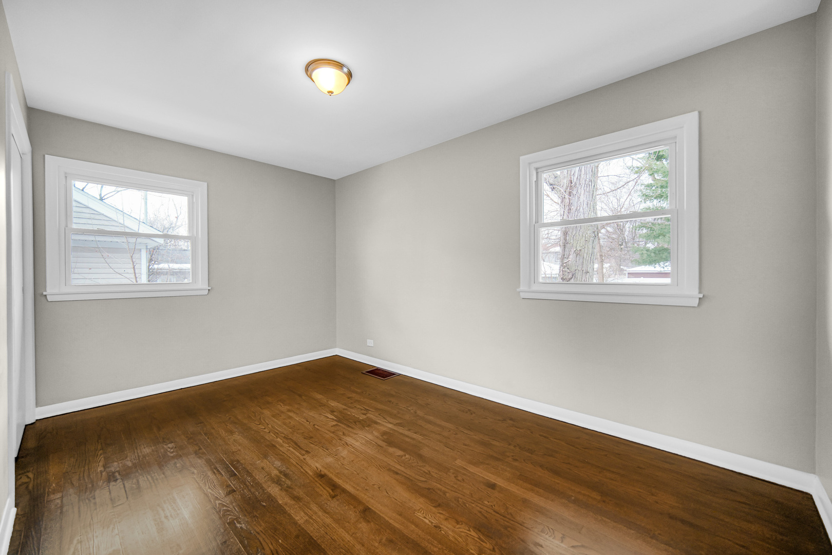 18144 Aberdeen Street Homewood, IL 60430 - Photo 10 of 25 a view of an empty room with wooden floor and a window