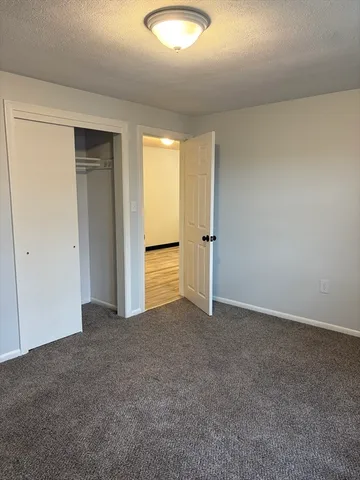 an empty room with closet and a bathroom